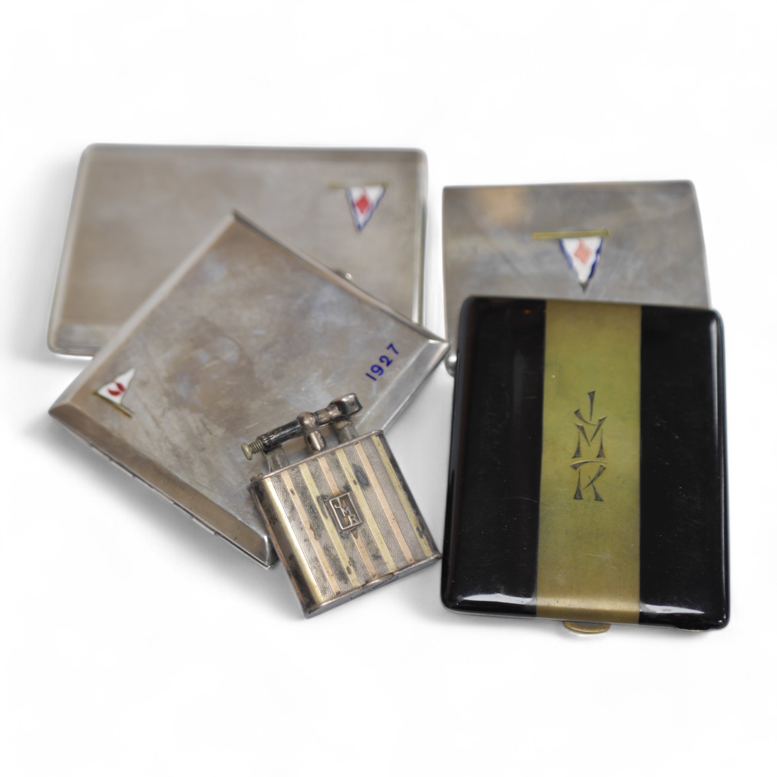 Three assorted George V silver and enamel cigarette cases, each decorated with a pennant, the largest by Benzies of Cowes, 11.6cm, one other French cigarette case and a 1920's silver lighter with import marks. Condition